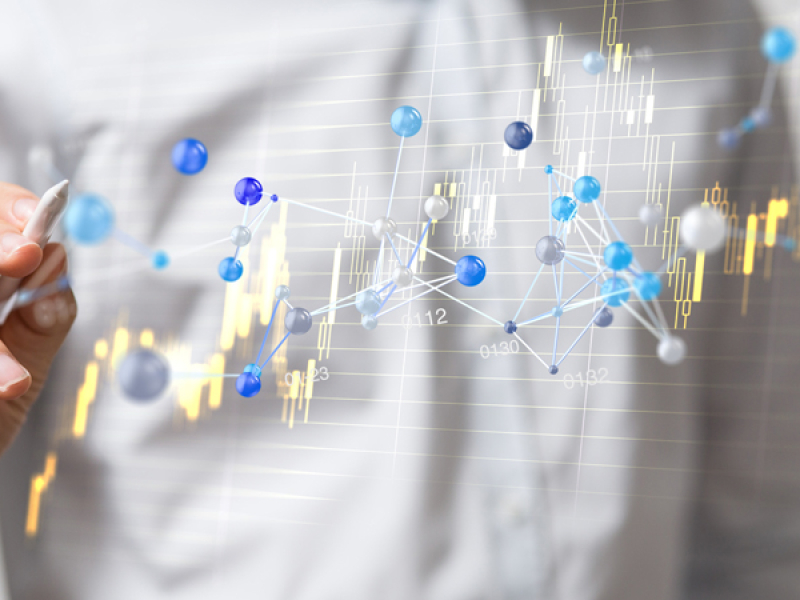 Photo illustration of man with pen pointing to chart data