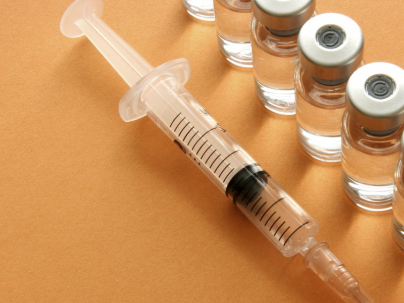 syringe and vaccine vials