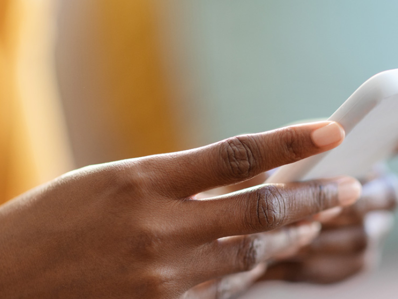 woman's hands holding a cell phone